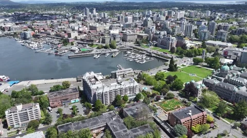 Hovering above James Bay district, left panning across Victoria Inner Harbor  Stock Footage 276334209