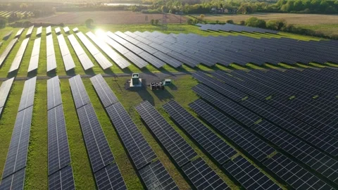 Hovering Aerial View of Solar Farm Array Glowing in Golden Evening Light Vídeos de archivo 346140421