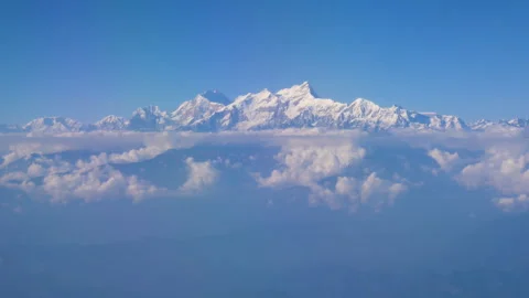 Hovering in the blue sky watching the mountain range shining with sunshine Stock Footage 281222030