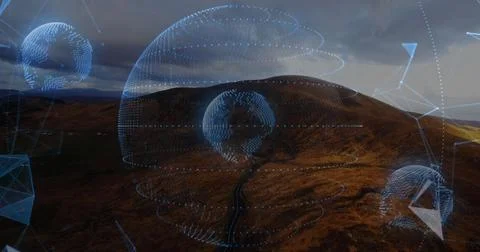Hovering central dotted globe over moorland valley, projecting rings and network Stock Photos
