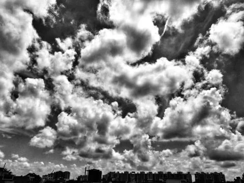 Hovering clouds over the city. Stock Photos