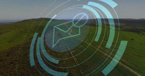 Hovering digital map pin icon with concentric circles over aerial fields showing Stock Photos