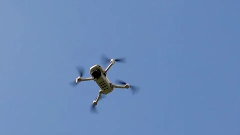 A hovering drone with a camera system that is attacked by flying insects Stock Footage 271228202