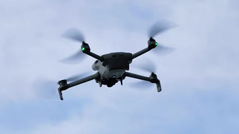 Hovering drone seen from the ground Stock Footage 337717659