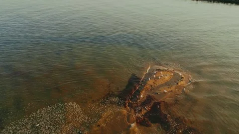 Hovering Drone Shot Of Waves Rolling Up On A Sandbar Island Full Of Birds Stock Footage 255350188