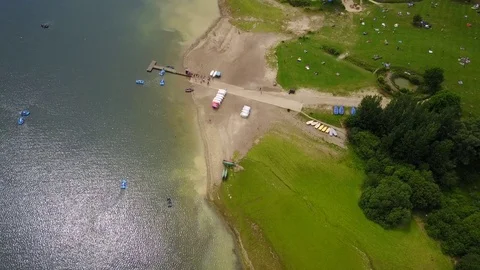 Hovering far above Bewl Water lake reservoir jetty in Lamberhurst, East Sussex Stock Footage 77074640