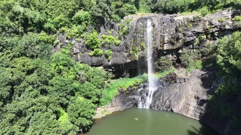 Hovering in front to the highest of the Seven Cascades waterfalls with rainbow  Stock Footage 275144848