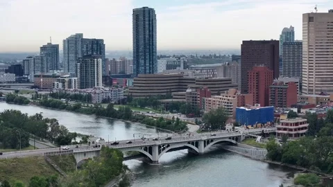Hovering in front of historic Centre St Bridge crossing the Bow River Stock Footage 343864031