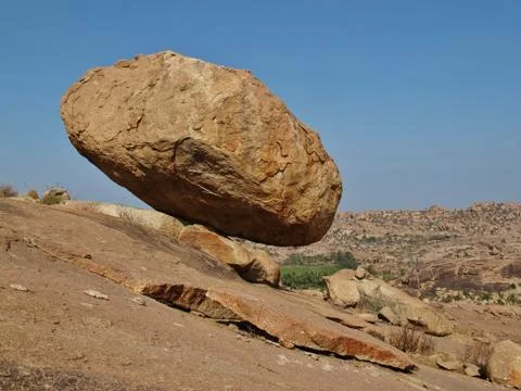 Hovering granite boulder in Hampi Stock Photos