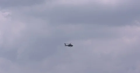 Hovering helicopter in cloudy sky - slowly moving up Stock Footage 91567367