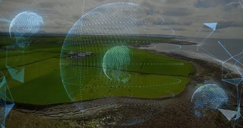 Hovering holographic sphere showing data globes above coast, with grazing herd Stock Photos