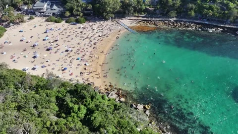 Hovering next to famous Shelly Beach (Manly), with many people sunbathing Stock Footage 327179548
