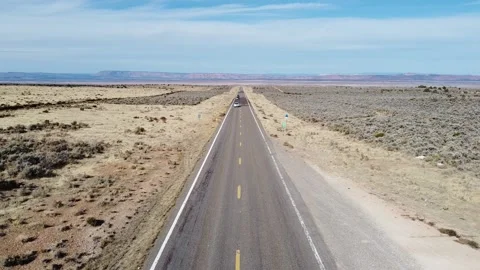 Hovering over a desert highway in Utah as cars pass underneath Video stock 153249163