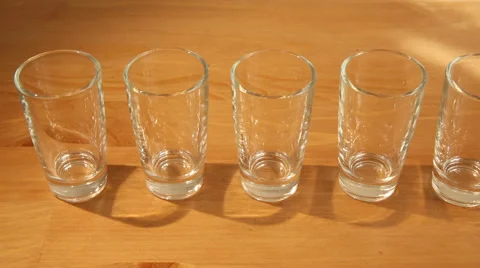 Hovering over many shot glasses Stock Footage 50363629