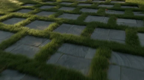 Hovering Over Pave Stones in a Lawn with Sun Glaring Stock Footage 61840262