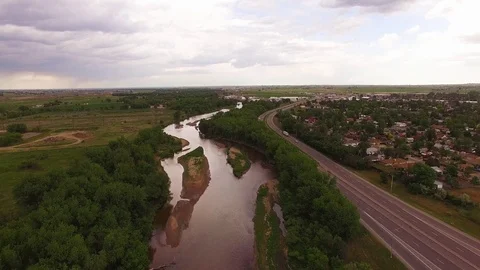 Hovering Over River and Road Facing South Far Color Corrected Stock Footage 98846828