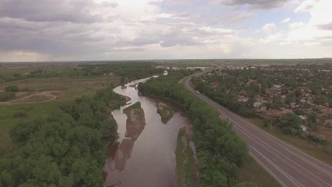 Hovering Over River and Road Facing South Far Stock Footage 98846999