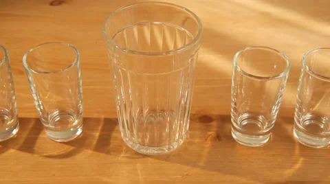 Hovering over small glasses and a big one 動画素材 50734437