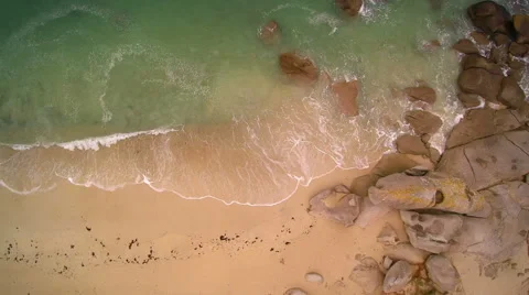 Hovering the seaside on the beach until a granite rock protrusion. Stock Footage 67658639