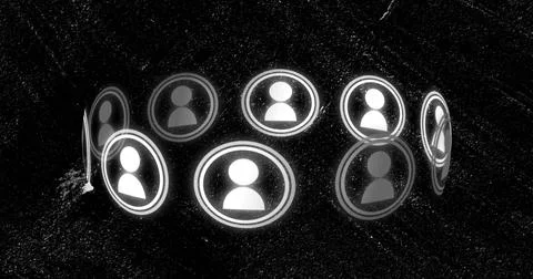 Hovering semicircular glowing user-avatar icons rotating above dark granular Stock Photos