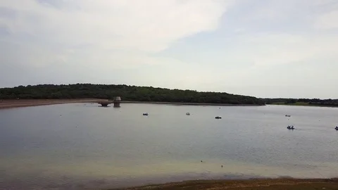 Hovering towards the horizon over Bewl Water lake reservoir Stock Footage 77105781