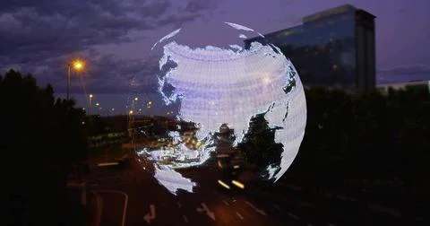 Hovering translucent globe hologram showing Asia above multi-lane road at dusk, Fotos de archivo