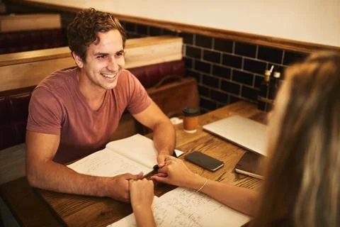 How am I supposed to study when youre around. a happy young student couple 스톡 사진