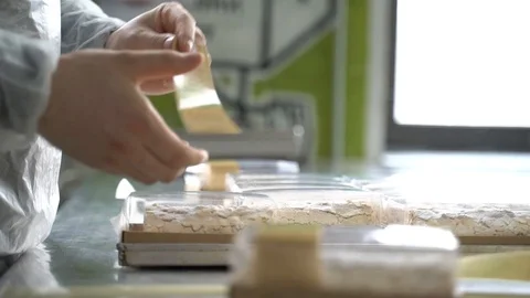 How to apply stickers on the packaging Stock Footage 127457850