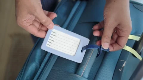 How to attach a luggage tag to your bag Stock Footage 340723653