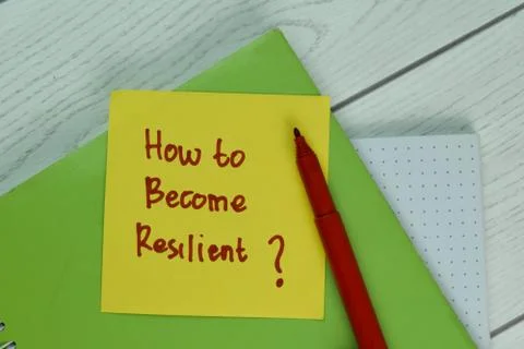 How To Become Resilient? write on a book isolated on Wooden Table. Foto stock