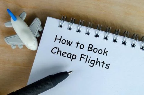 How to book a cheap flights text on white notepad with airplane and black p.. Stock Photos