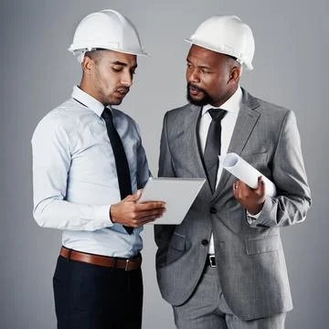 How can we improve this design. two civil engineers discussing building plans Fotos de archivo