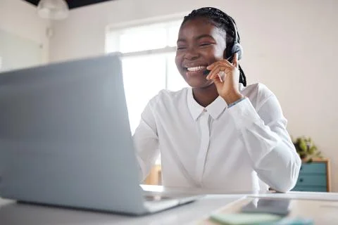 How can we improve your life. a young businesswoman using a headset and laptop Stock Photos