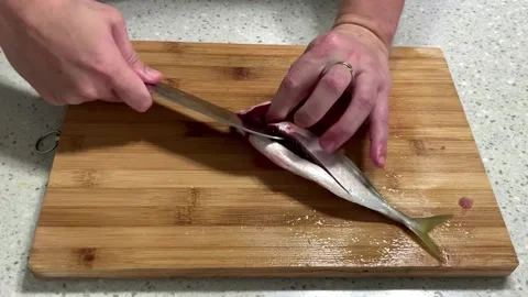 How to clean a small fish the simple way Stock Footage 165088419