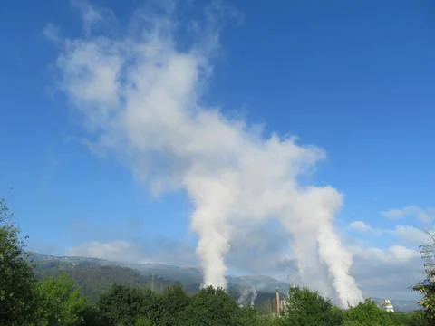 How clouds are made with polluting smoke from industry chimneys Stock Photos