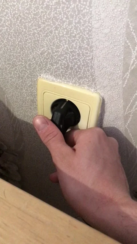 How to connect an electrical plug to a wall outlet safely Stock Footage 308368487