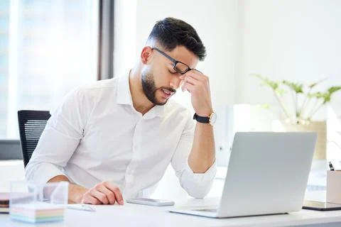 How do I keep forgetting. a handsome young businessman sitting alone in the Stock Photos