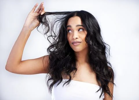 How do I sort out these dry ends. an attractive young woman standing alone in Stock Photos