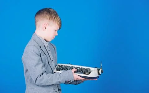 How does a retro typing machine work. Smart child using retro technology. Cute Stock Photos