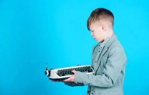 How does a retro typing machine work. Smart child using retro technology. Cute Stock Photos