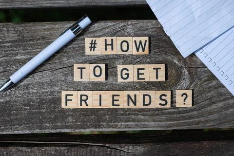 How to get friends question letters on wooden blocks on a wooden table Stock Photos