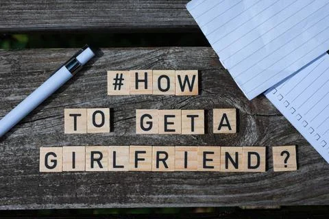 How to get a girlfriend question letters on wooden blocks on a wooden table Stock Photos