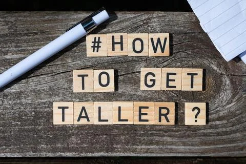 How to get taller question letters on wooden blocks on a wooden table Stock Photos