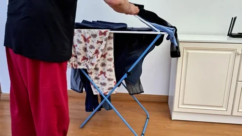 How to Hang Laundry on an Indoor Drying Rack for Fast Efficient Drying Stock Footage 338317570