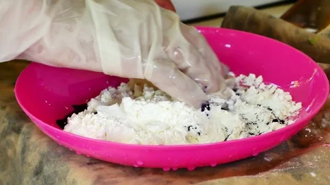 How to make colored powder, holi Festival. The hands are salting food colorin Stock Footage 83473044