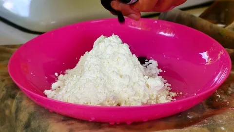 How to make colored powder, holi Festival. The hands are salting food colorin Stock Footage 83473071