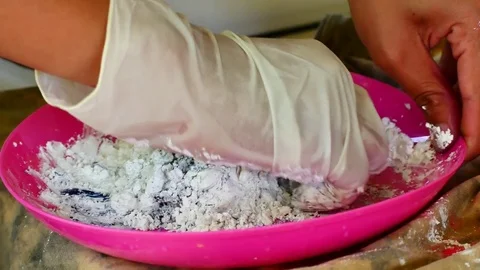 How to make colored powder, holi Festival. The hands are salting food colorin Stock Footage 83473133