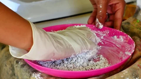 How to make colored powder, holi Festival. The hands are salting food colorin Stock Footage 83473185