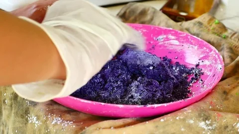 How to make colored powder, holi Festival. The hands are salting food colorin Stock Footage 83473342