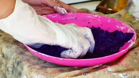 How to make colored powder, holi Festival. The hands are salting food colorin Stock Footage 83473408